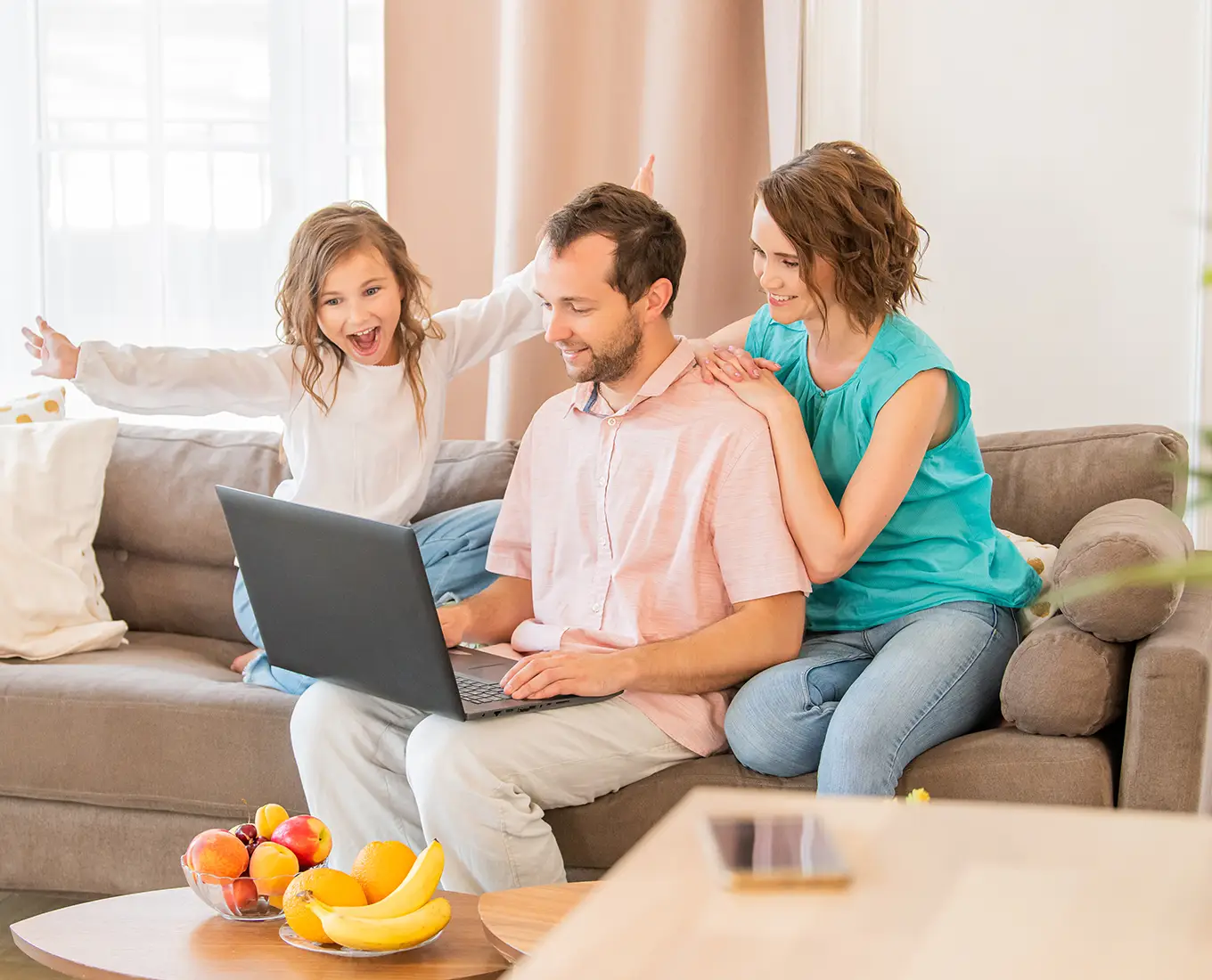 Family sitting comfortably at home in Farmington, MO showcasing they received Air Conditioning Services.