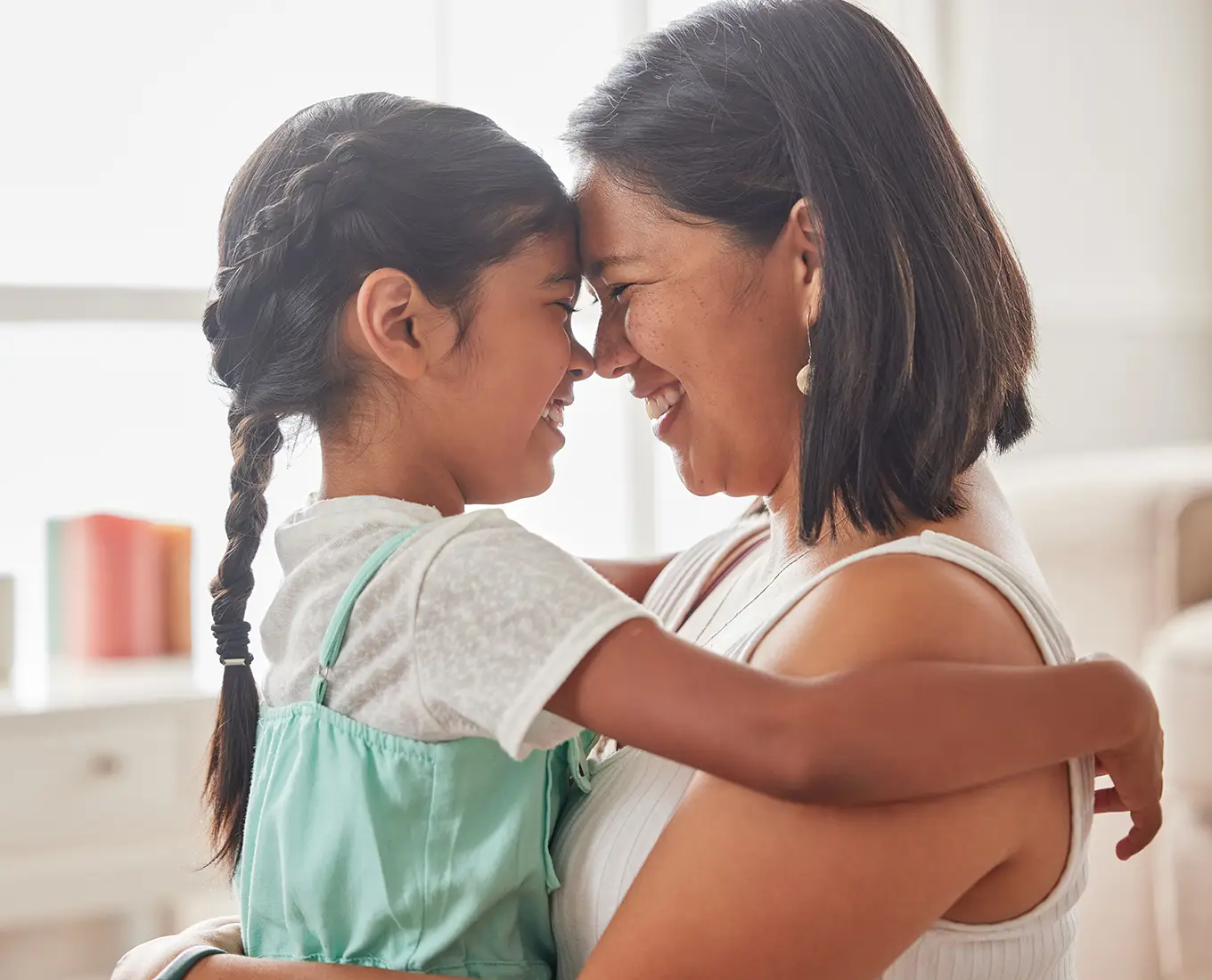Mother and daughter enjoying cool indoor comfort thanks to professional air conditioning services in Farmington, MO.