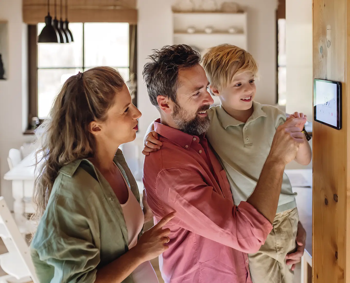 Homeowners adjusting thermostat after expert furnace repair and heating service in Farmington, MO.