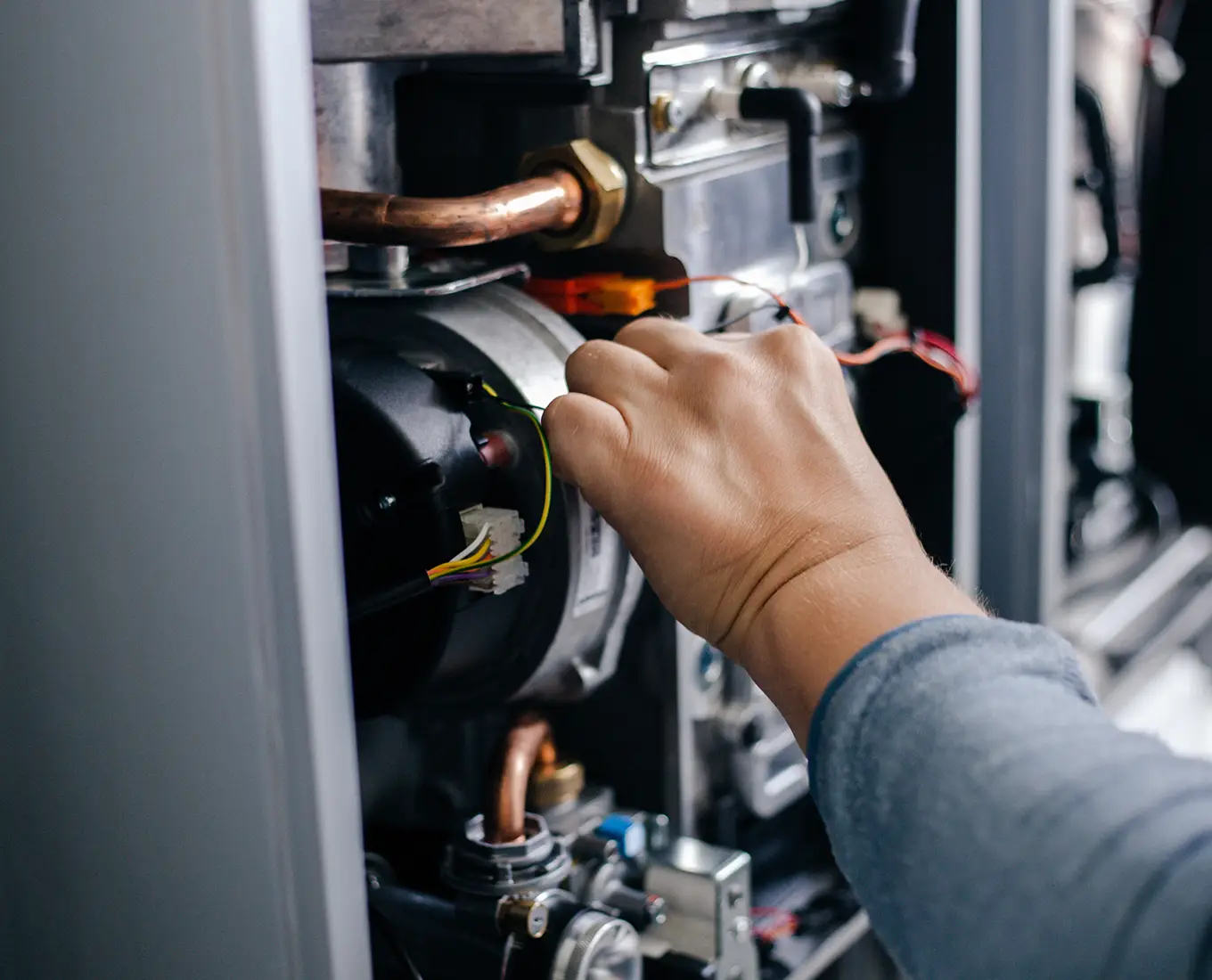 HVAC technician performing detailed furnace maintenance inspection in Farmington, MO.